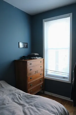 a room with a window and dresser