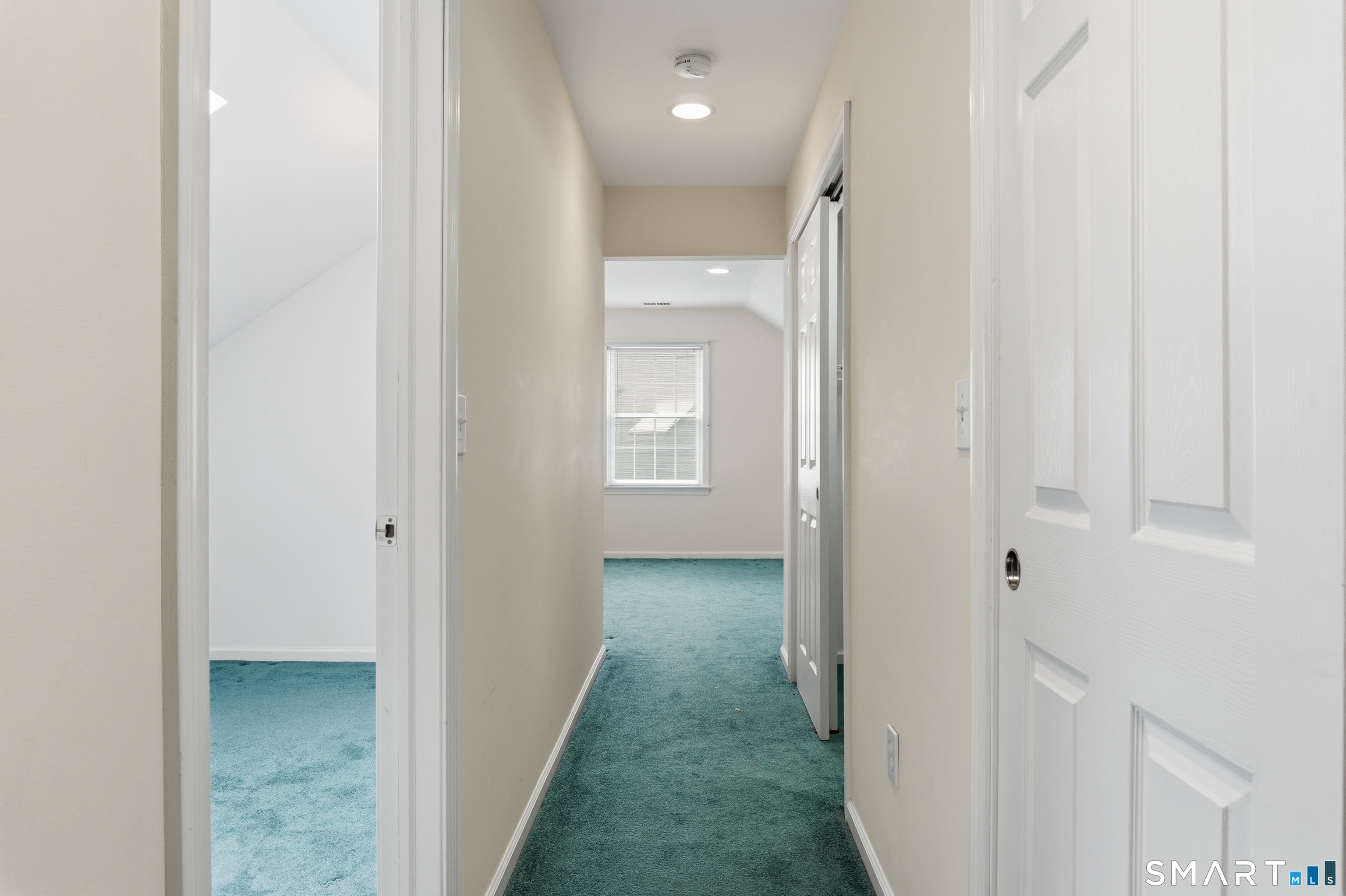 202 Stoney Way, Unit 202 New Fairfield, CT 06812 - Photo 12 of 18 a view of a hallway with wooden floor and entryway