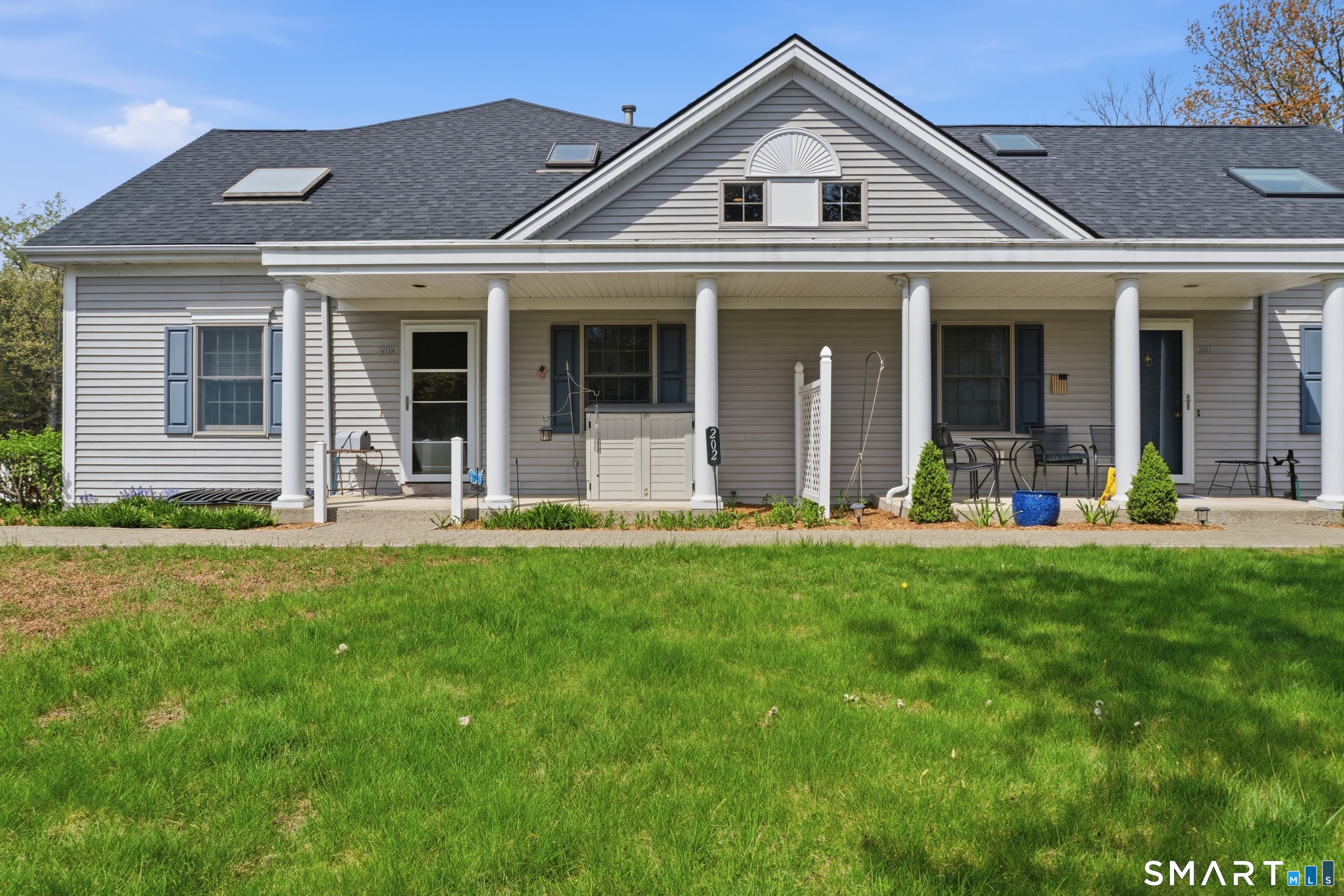 202 Stoney Way, Unit 202 New Fairfield, CT 06812 - Photo 2 of 18 front view of a house with a yard