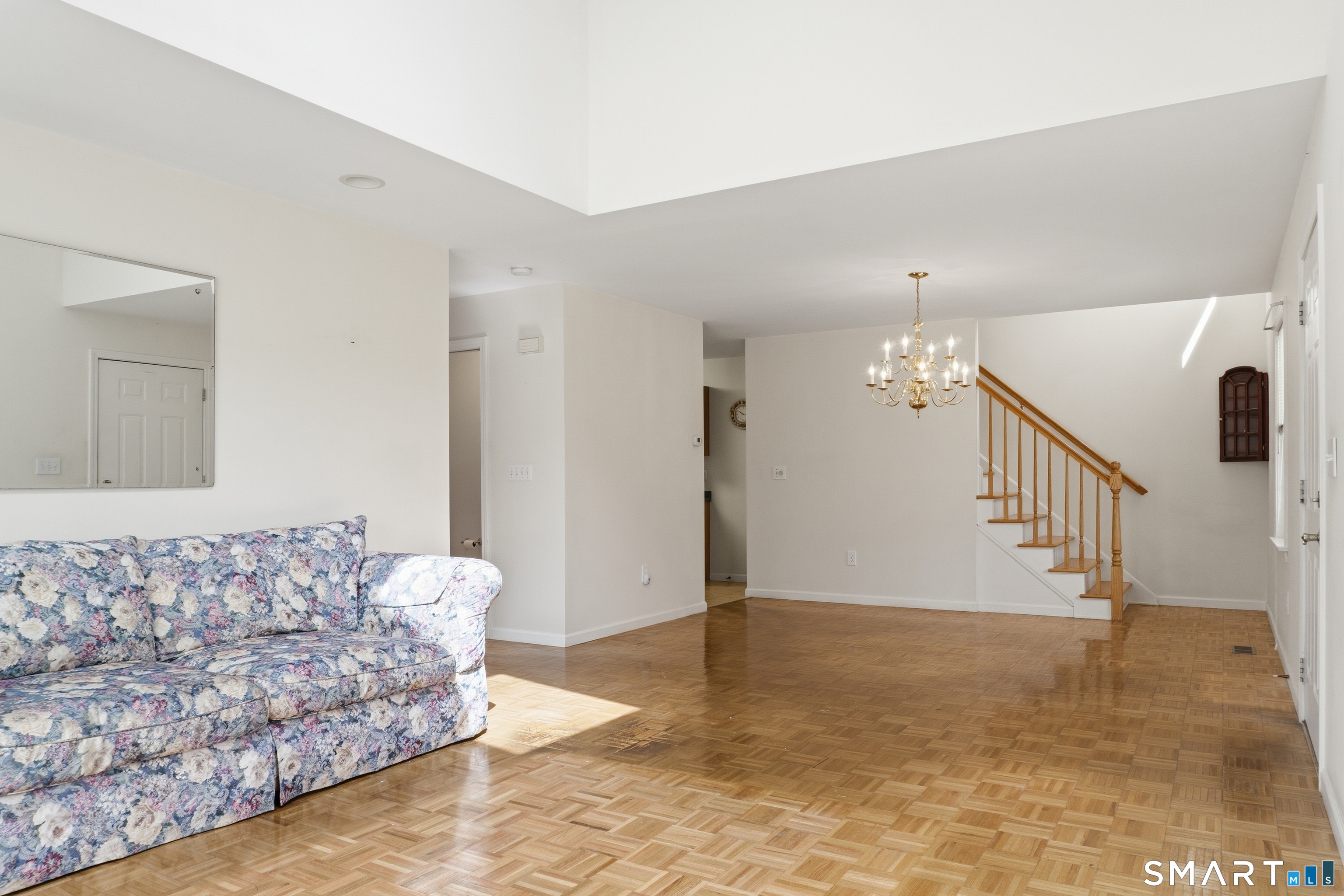 202 Stoney Way, Unit 202 New Fairfield, CT 06812 - Photo 4 of 18 a living room with furniture and wooden floor