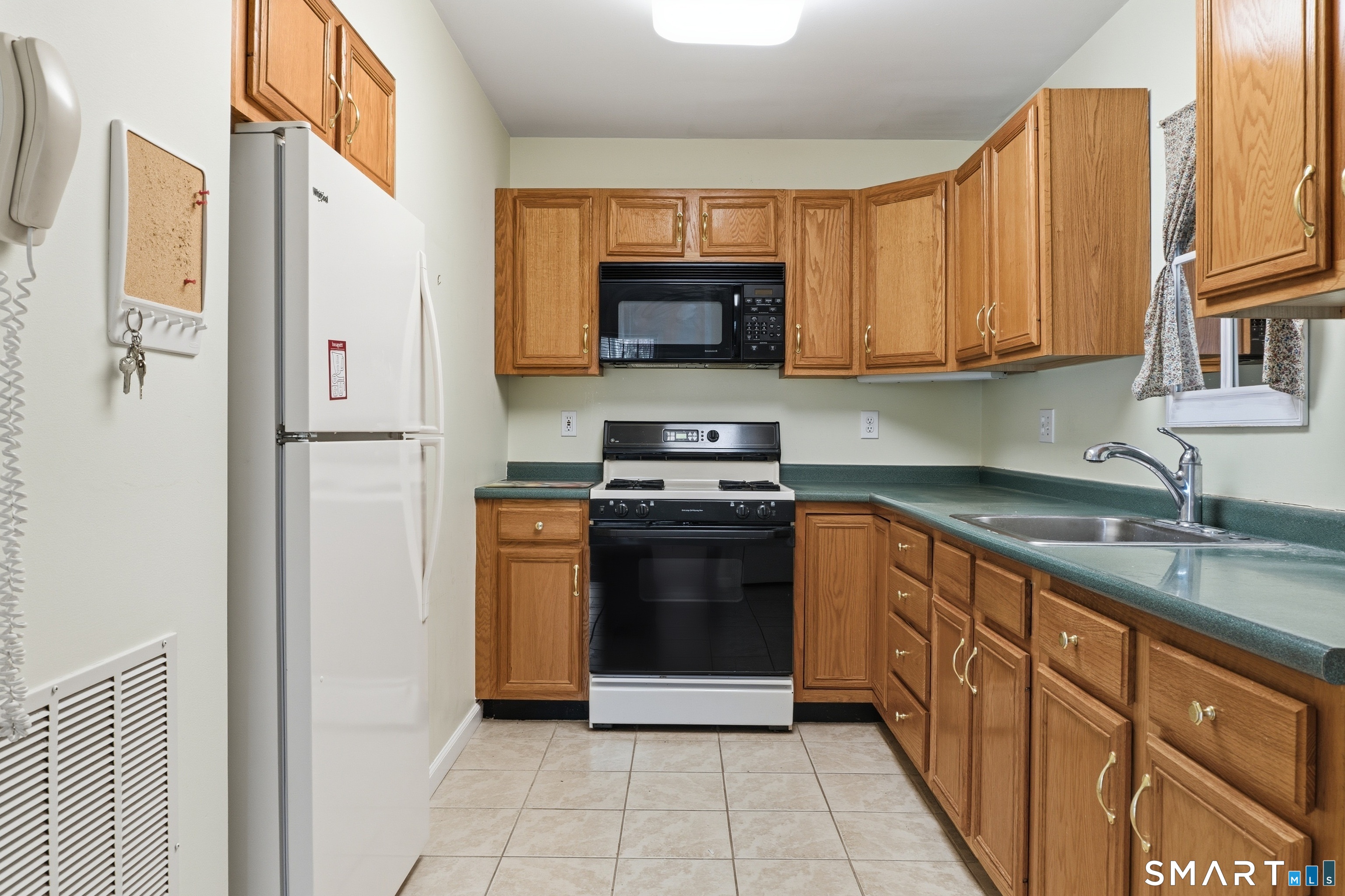 202 Stoney Way, Unit 202 New Fairfield, CT 06812 - Photo 7 of 18 a kitchen with stainless steel appliances granite countertop a stove a sink and a refrigerator