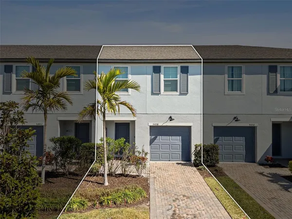 an aerial view of a house with swimming pool and patio