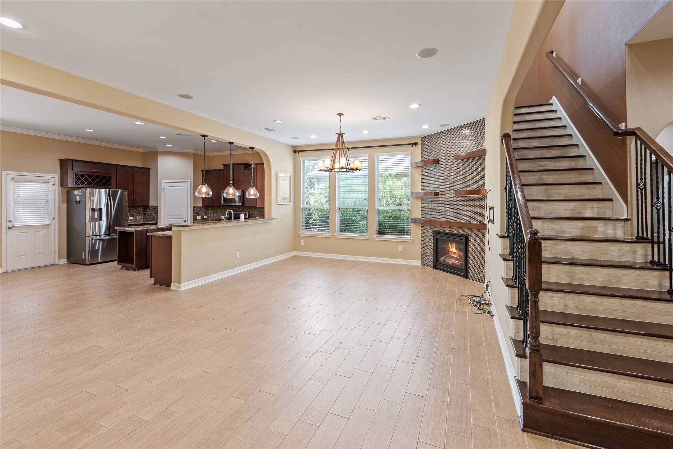 7423 Summer Night Lane Rosenberg, TX 77469 - Photo 15 of 44 an empty room with wooden floor fireplace and windows