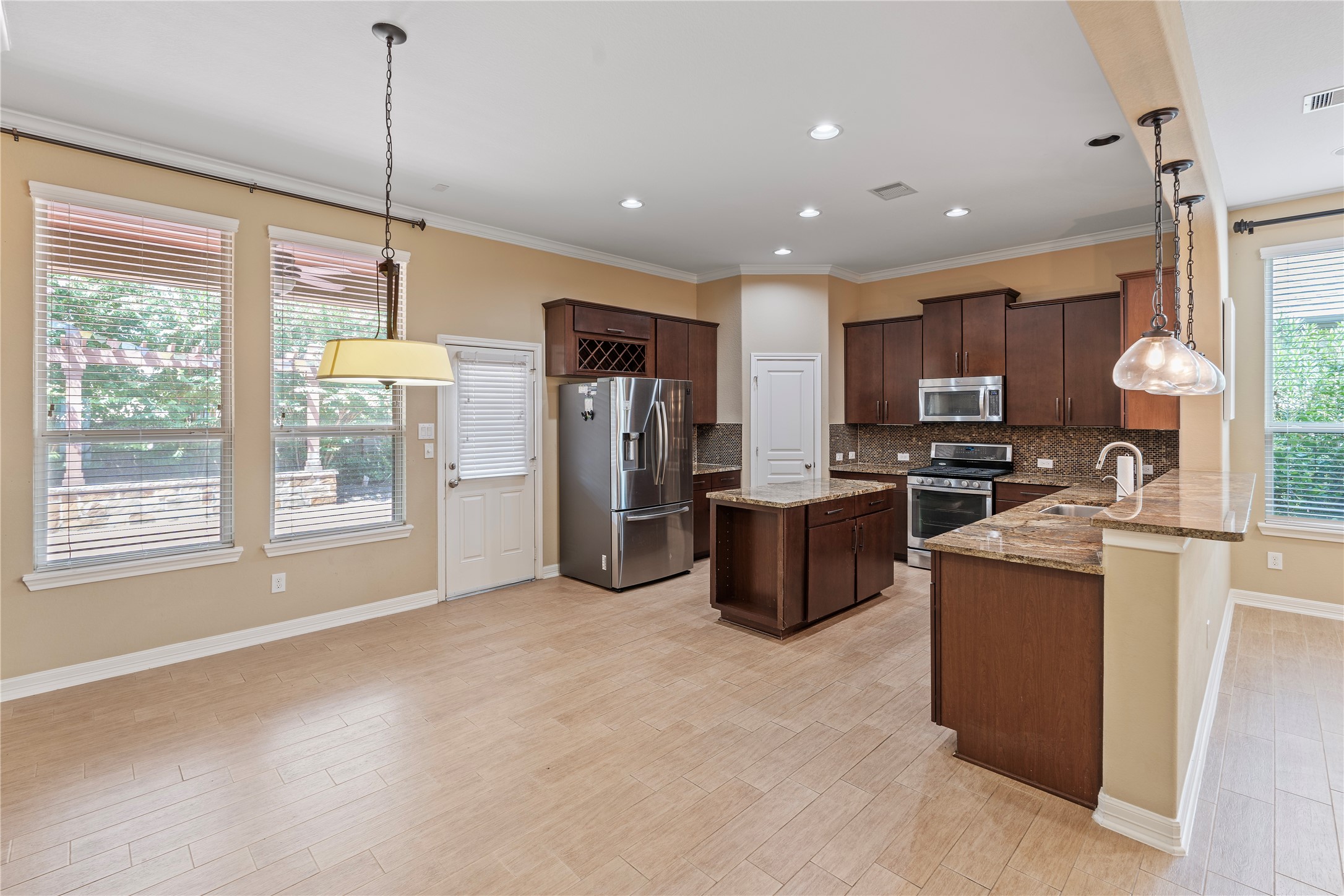 7423 Summer Night Lane Rosenberg, TX 77469 - Photo 19 of 44 a kitchen with stainless steel appliances granite countertop a refrigerator a oven a sink a stove and a window