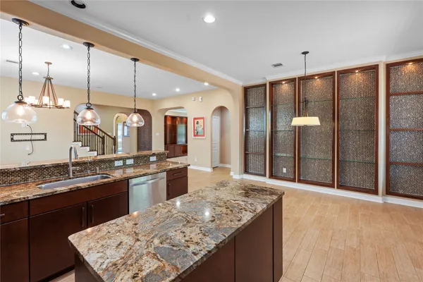 a large kitchen with kitchen island a counter space a sink appliances and cabinets