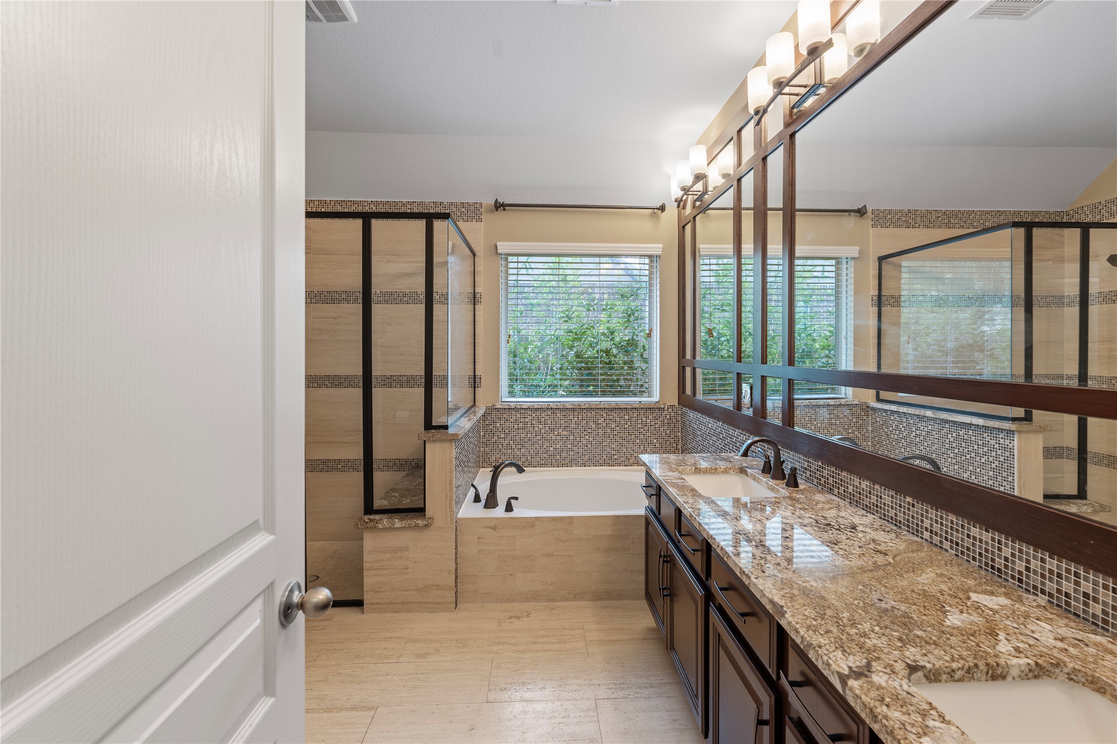 7423 Summer Night Lane Rosenberg, TX 77469 - Photo 28 of 44 a spacious bathroom with a granite countertop tub and a large window