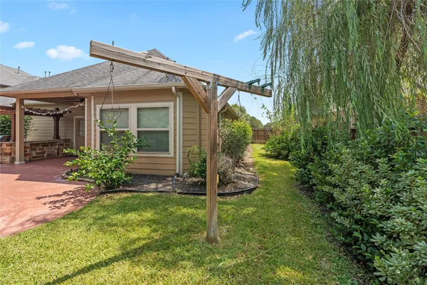 a view of a house with backyard sitting area and garden