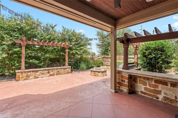 a view of a patio with table and chairs under an umbrella