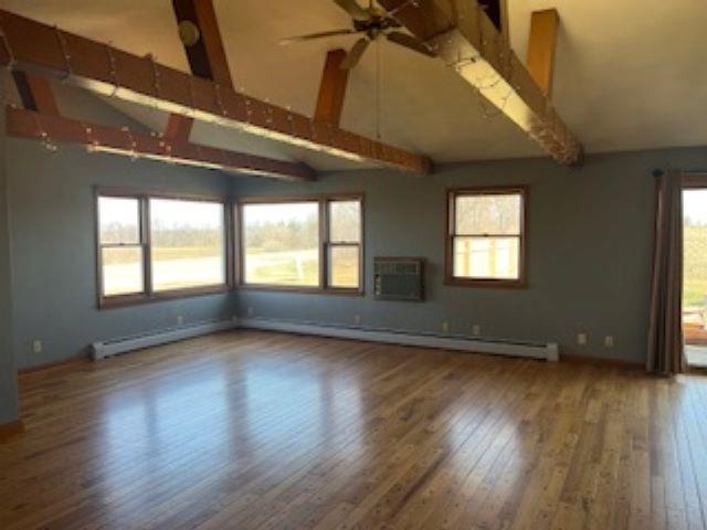 12926 Freeport Road Durand, IL 61024 - Photo 6 of 33 a view of an empty room with wooden floor and a window