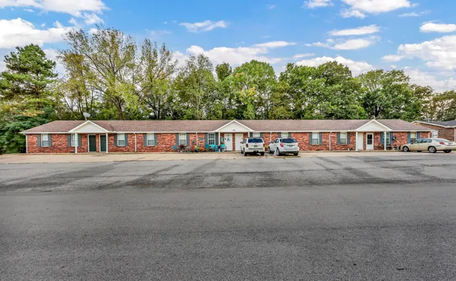 a view of house with trees in the background