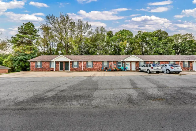a view of house with outdoor space and sitting area