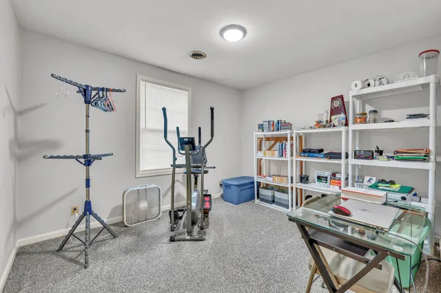 a bench sitting in a room next to a window