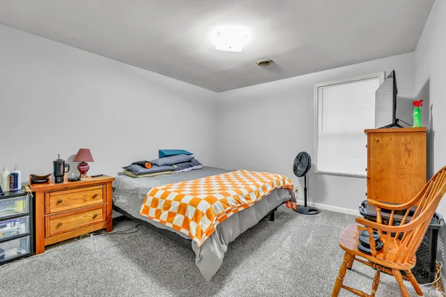 a bedroom with a bed and dresser