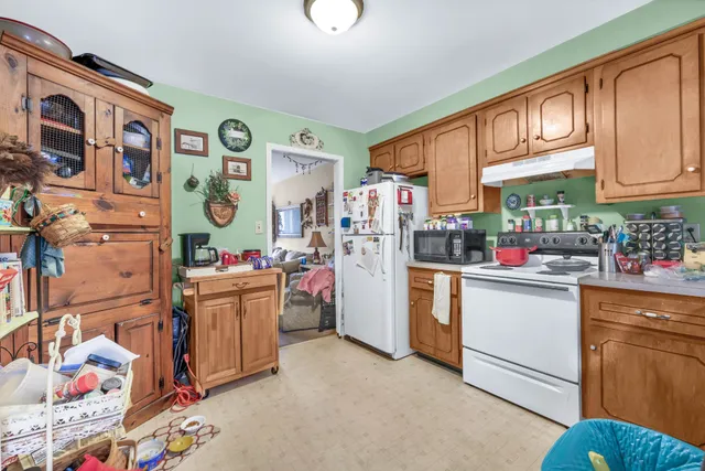 a kitchen with stainless steel appliances granite countertop a refrigerator and dishwasher
