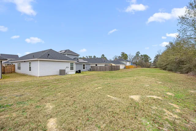 a view of house with yard and ocean view