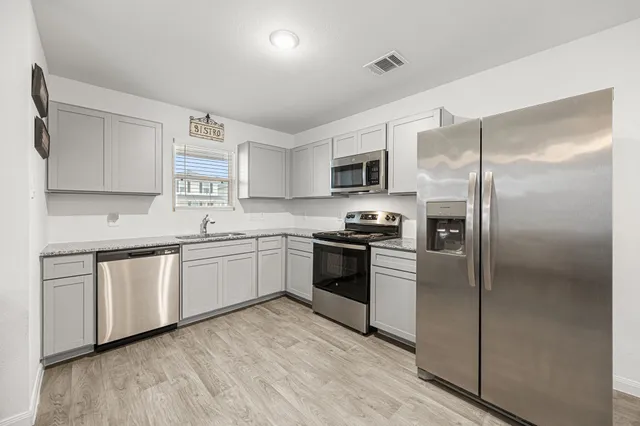 a kitchen with a refrigerator stove and microwave
