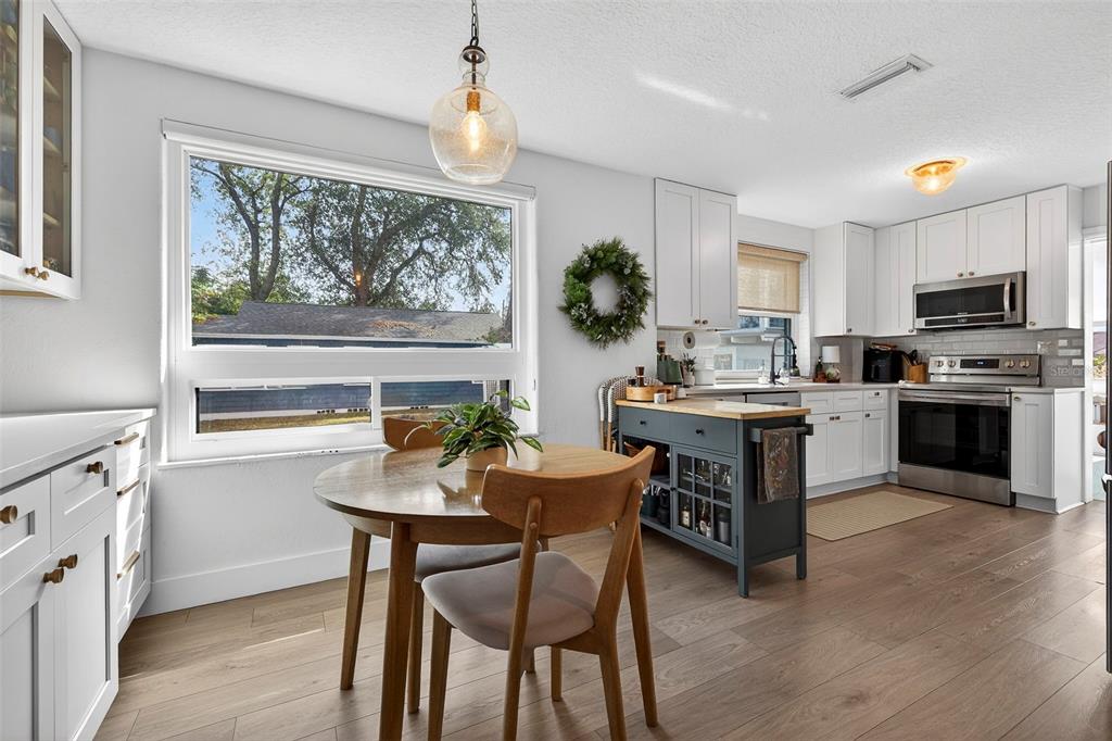 2220 7th Avenue North St. Petersburg, FL 33713 - Photo 11 of 31 a kitchen with a table chairs microwave and cabinets