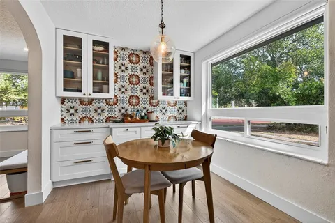 a dining room with furniture and window