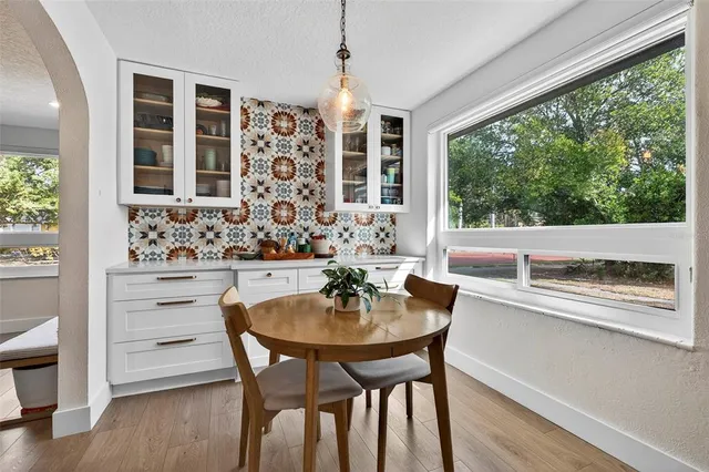 a dining room with furniture and window