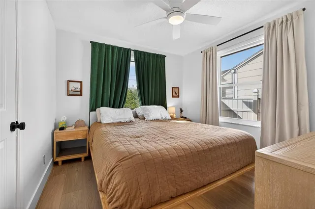 a bedroom with a bed and a large window