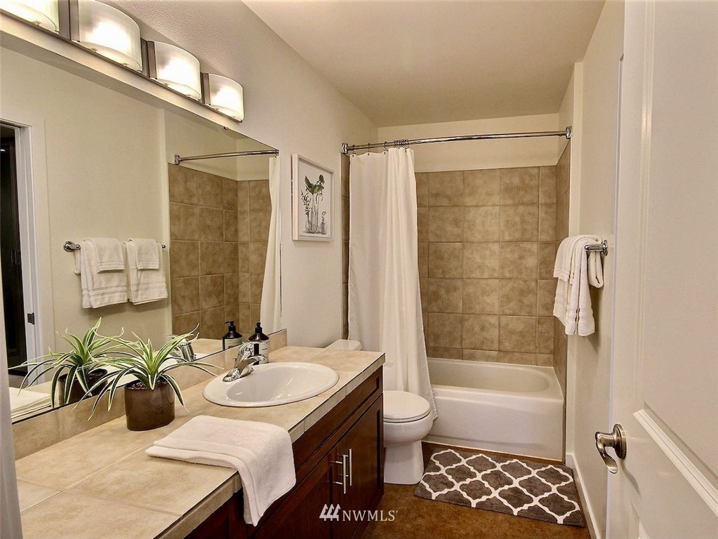3903 243rd Place Southeast, Unit N202 Bothell, WA 98021 - Photo 14 of 34 a bathroom with a sink and a mirror