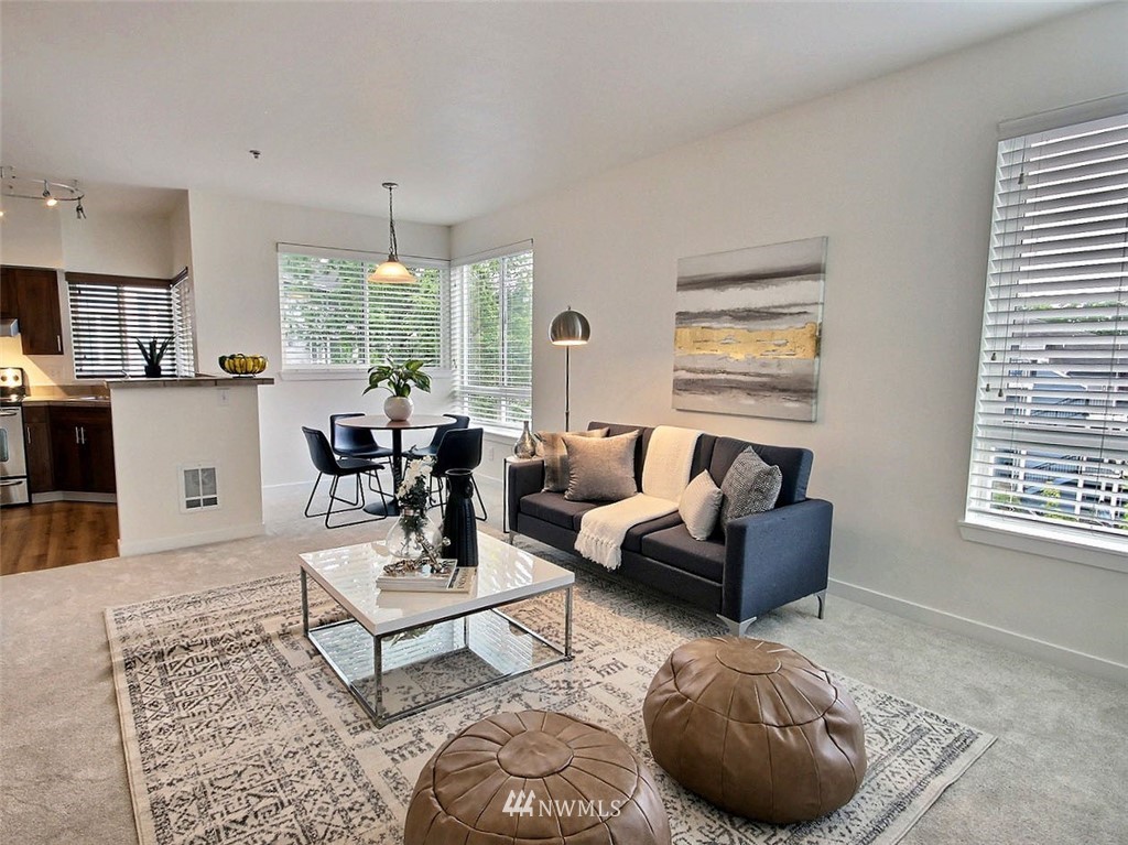 3903 243rd Place Southeast, Unit N202 Bothell, WA 98021 - Photo 8 of 34 a living room with furniture and a large window