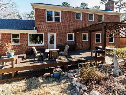 a front view of a house with yard tree and wooden fence