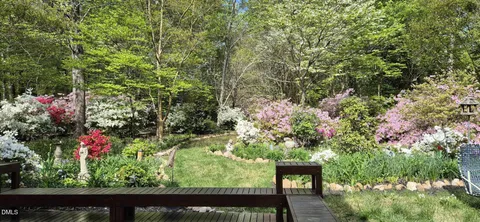 a view of a house with a yard and garden