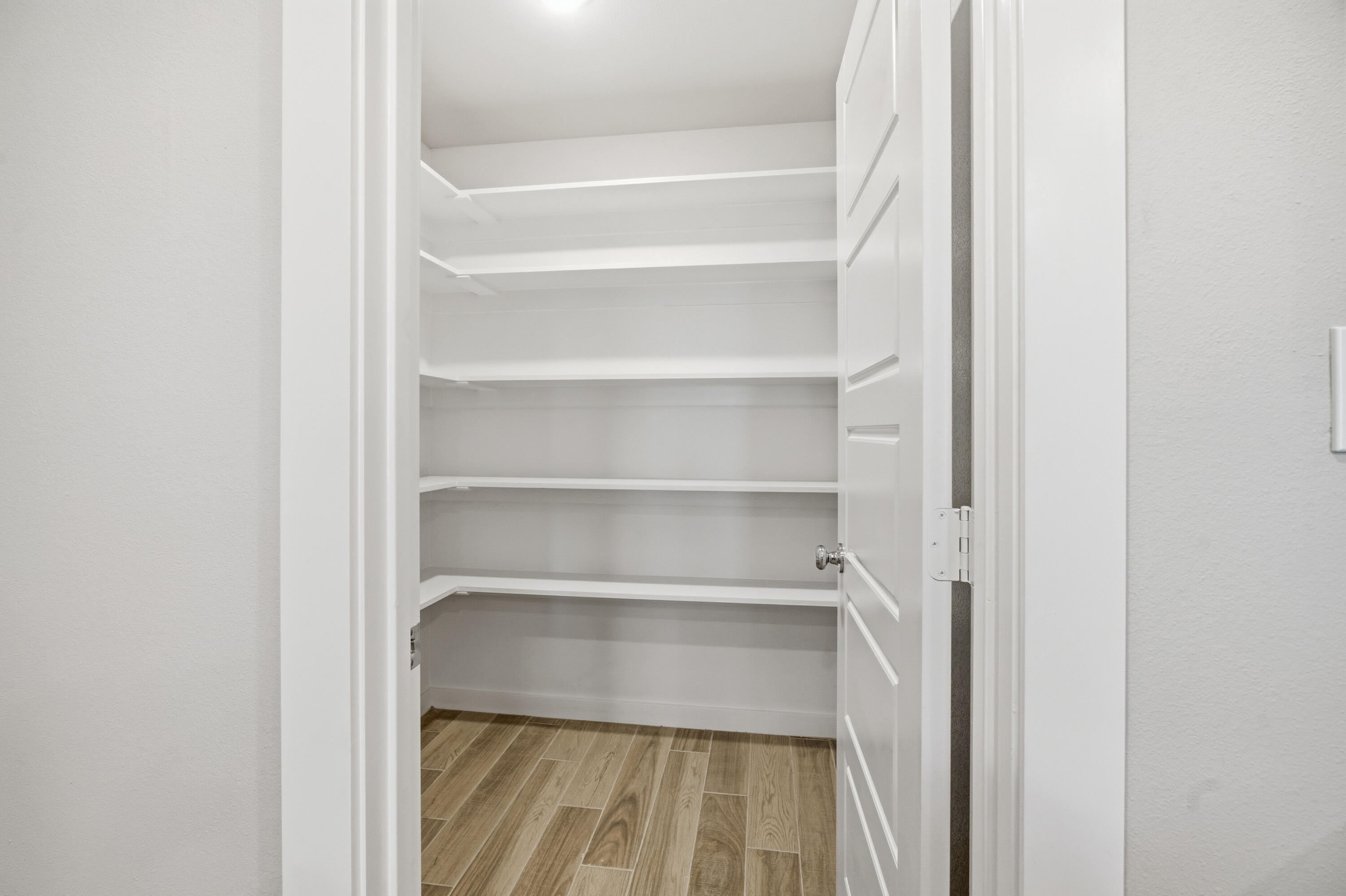 618 East 13th Street Wolfforth, TX 79382 - Photo 11 of 33 a view of walk in closet with empty racks