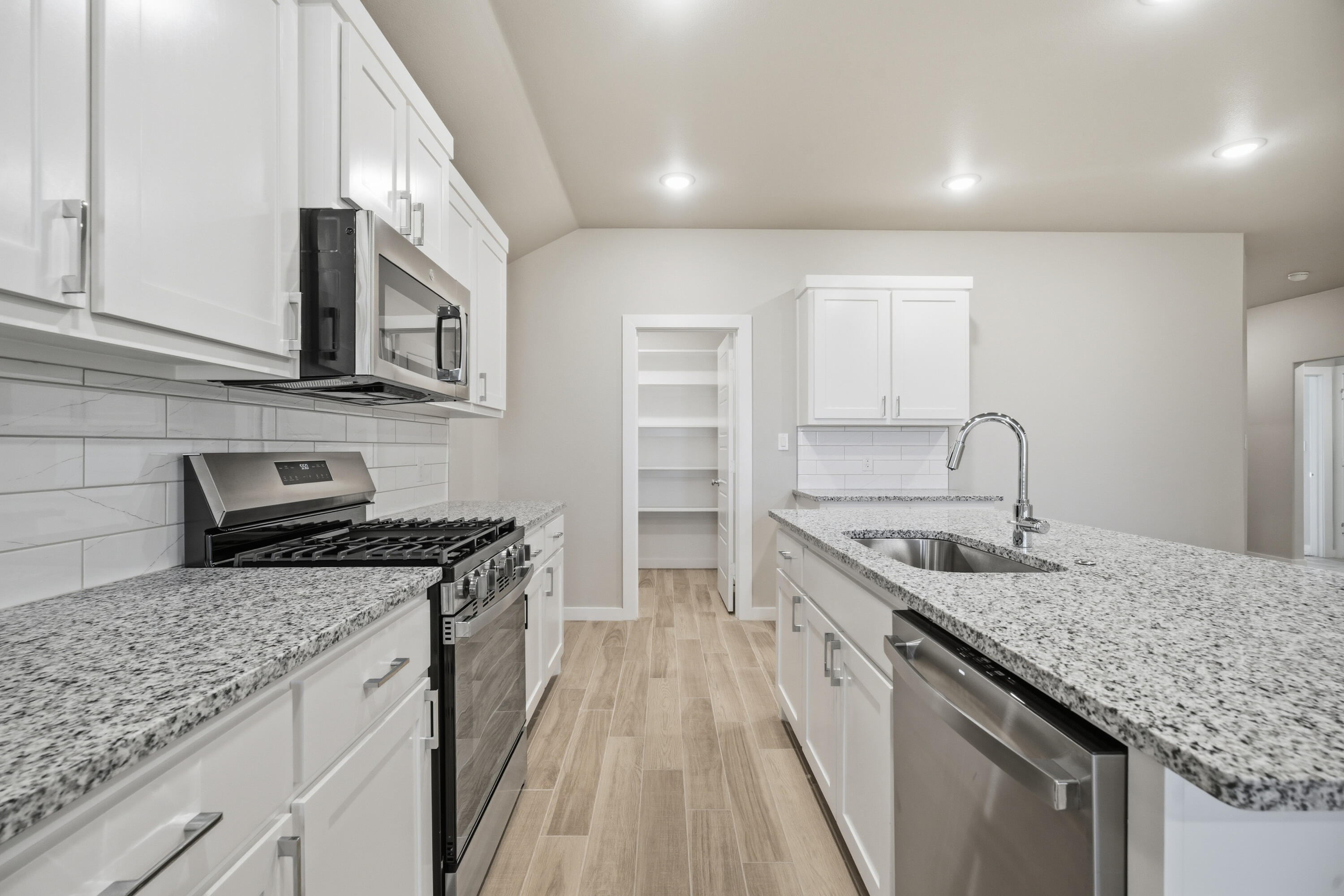 618 East 13th Street Wolfforth, TX 79382 - Photo 12 of 33 a kitchen with a sink stove and cabinets
