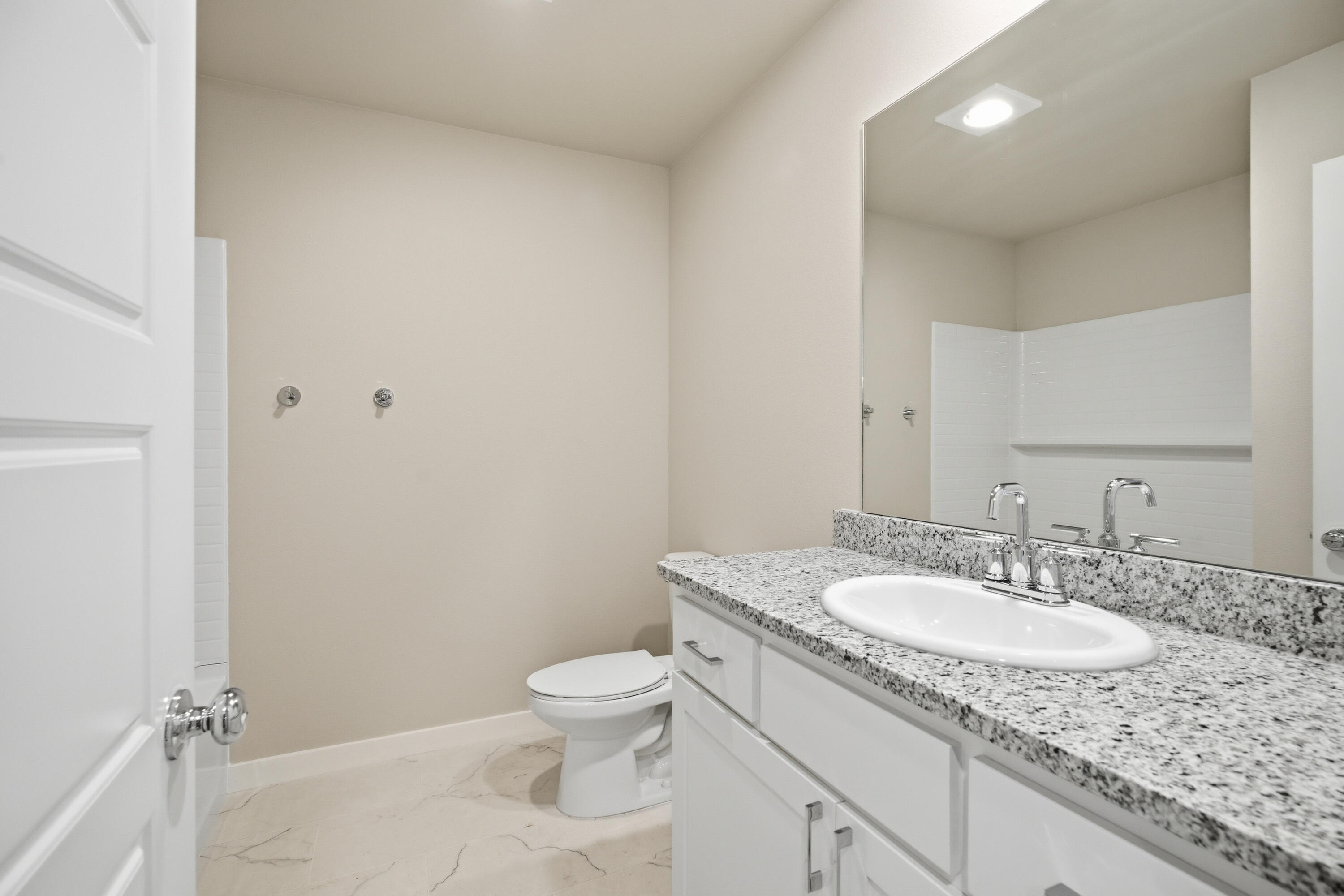 618 East 13th Street Wolfforth, TX 79382 - Photo 27 of 33 a bathroom with a granite countertop sink a toilet and a mirror