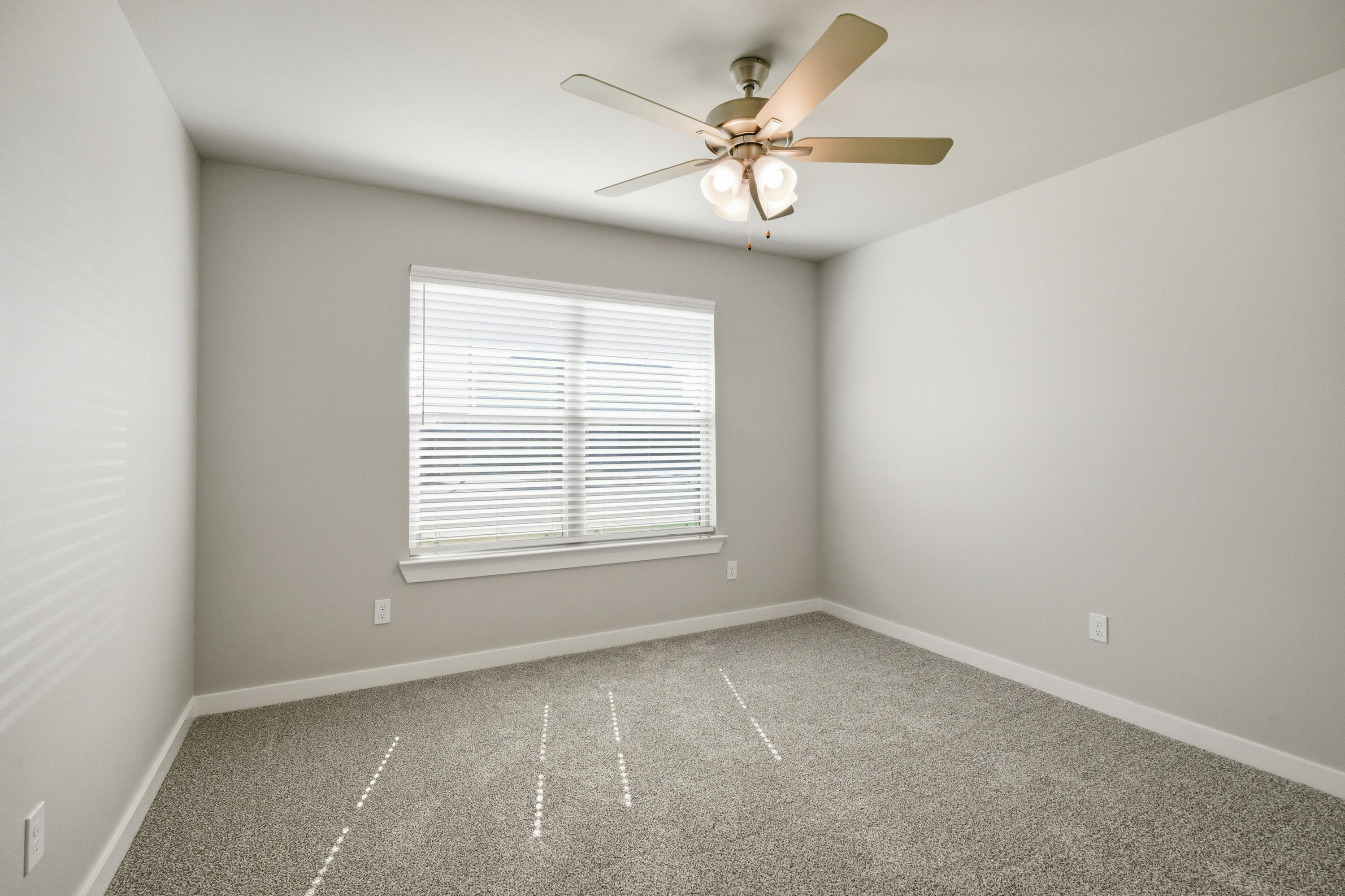618 East 13th Street Wolfforth, TX 79382 - Photo 29 of 33 an empty room with a chandelier fan and windows