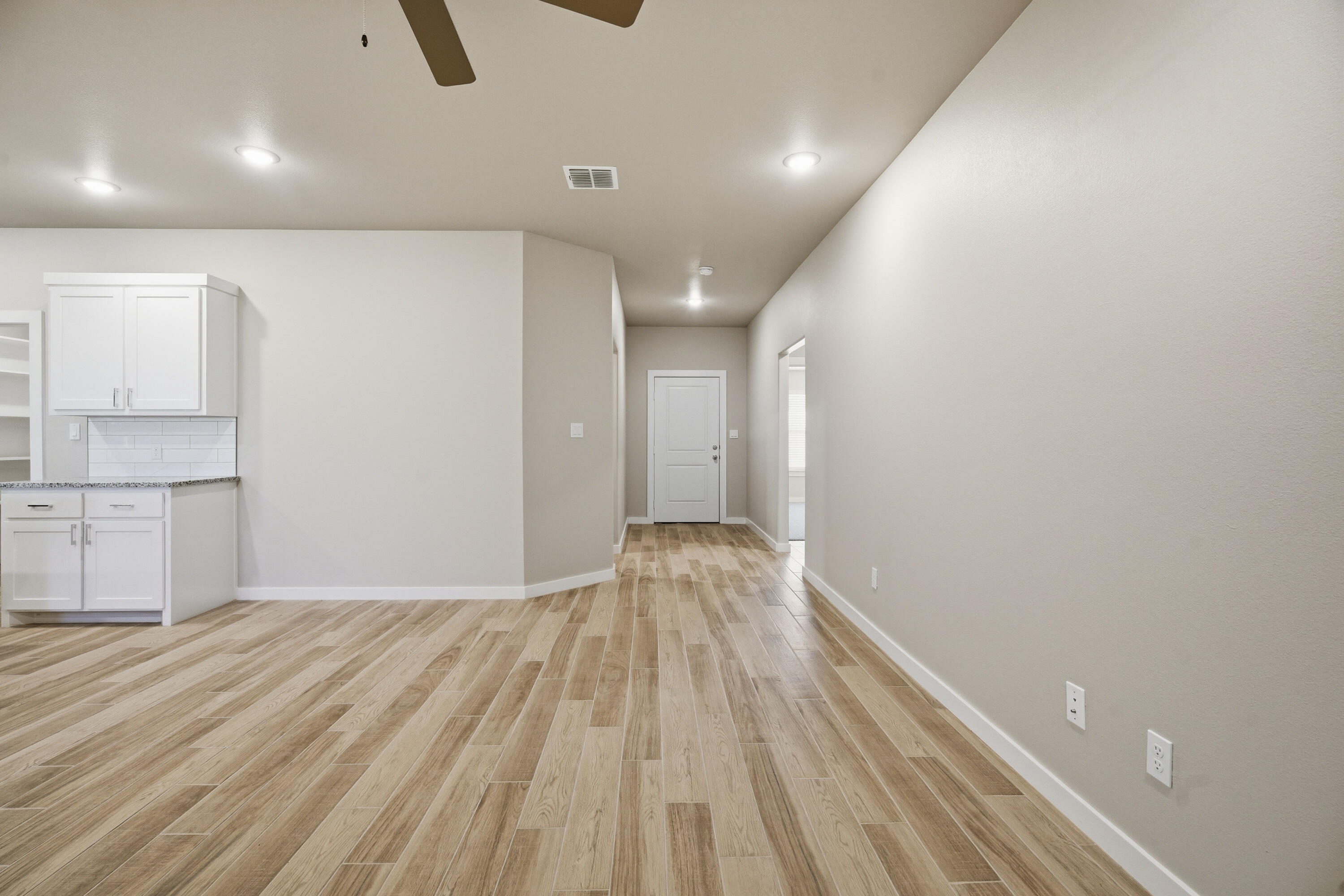 618 East 13th Street Wolfforth, TX 79382 - Photo 4 of 33 a view of empty room with wooden floor