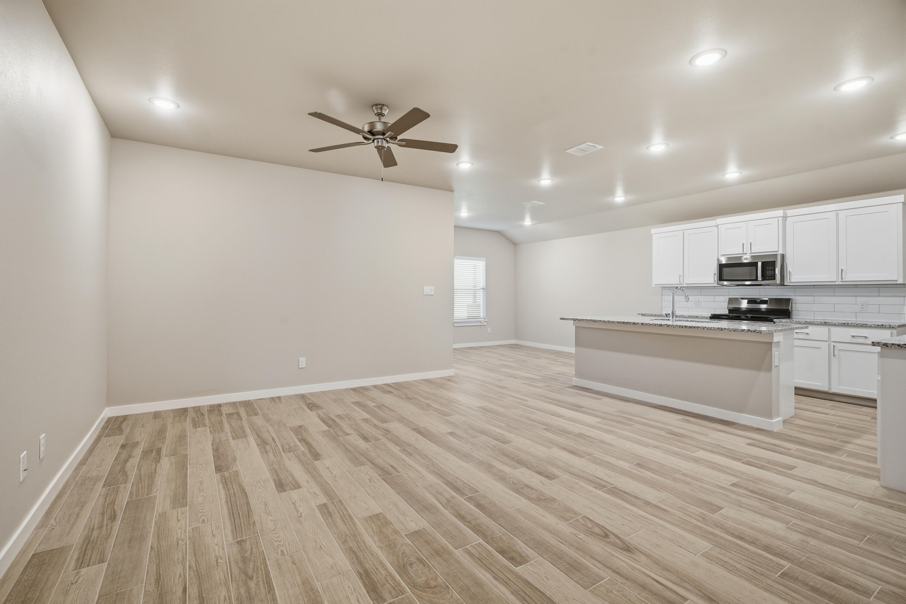 618 East 13th Street Wolfforth, TX 79382 - Photo 6 of 33 a view of kitchen with wooden floor electronic appliances and window