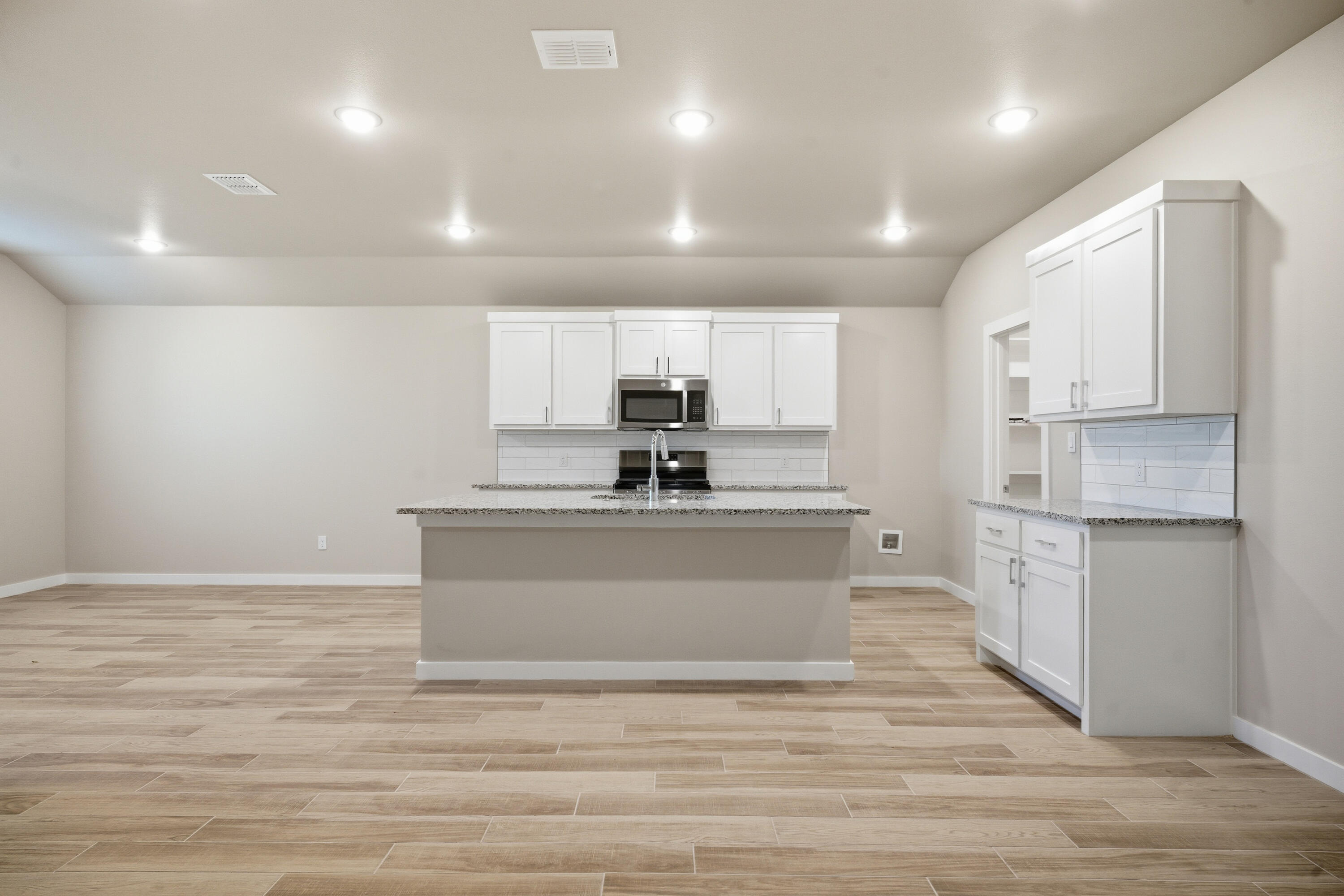 618 East 13th Street Wolfforth, TX 79382 - Photo 7 of 33 a view of kitchen with stainless steel appliances granite countertop a stove a sink and white cabinets