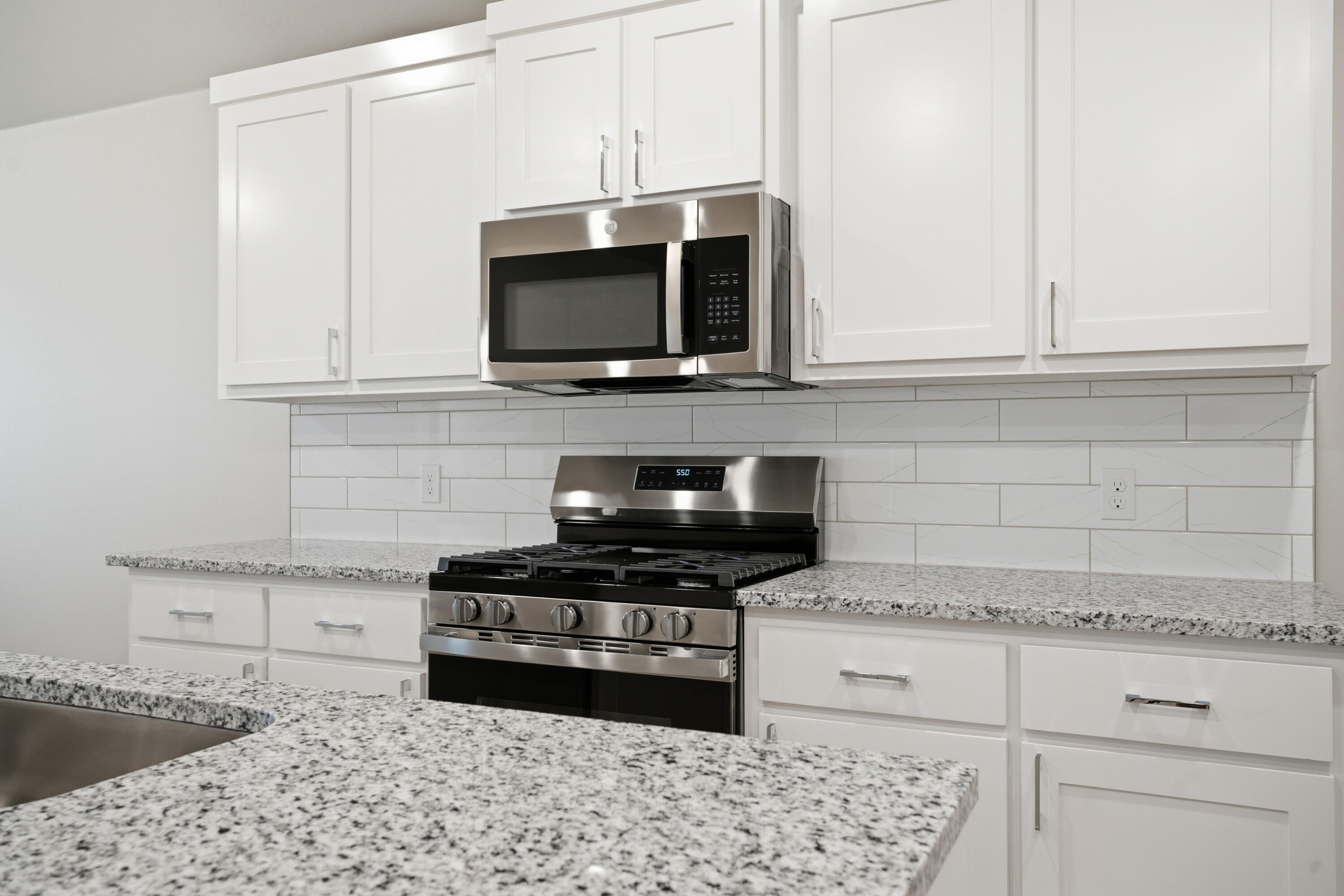 618 East 13th Street Wolfforth, TX 79382 - Photo 8 of 33 a kitchen with white cabinets and appliances