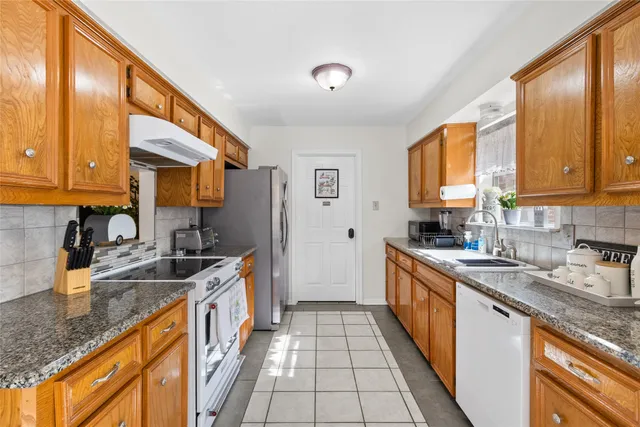 a kitchen with a sink stove and cabinets