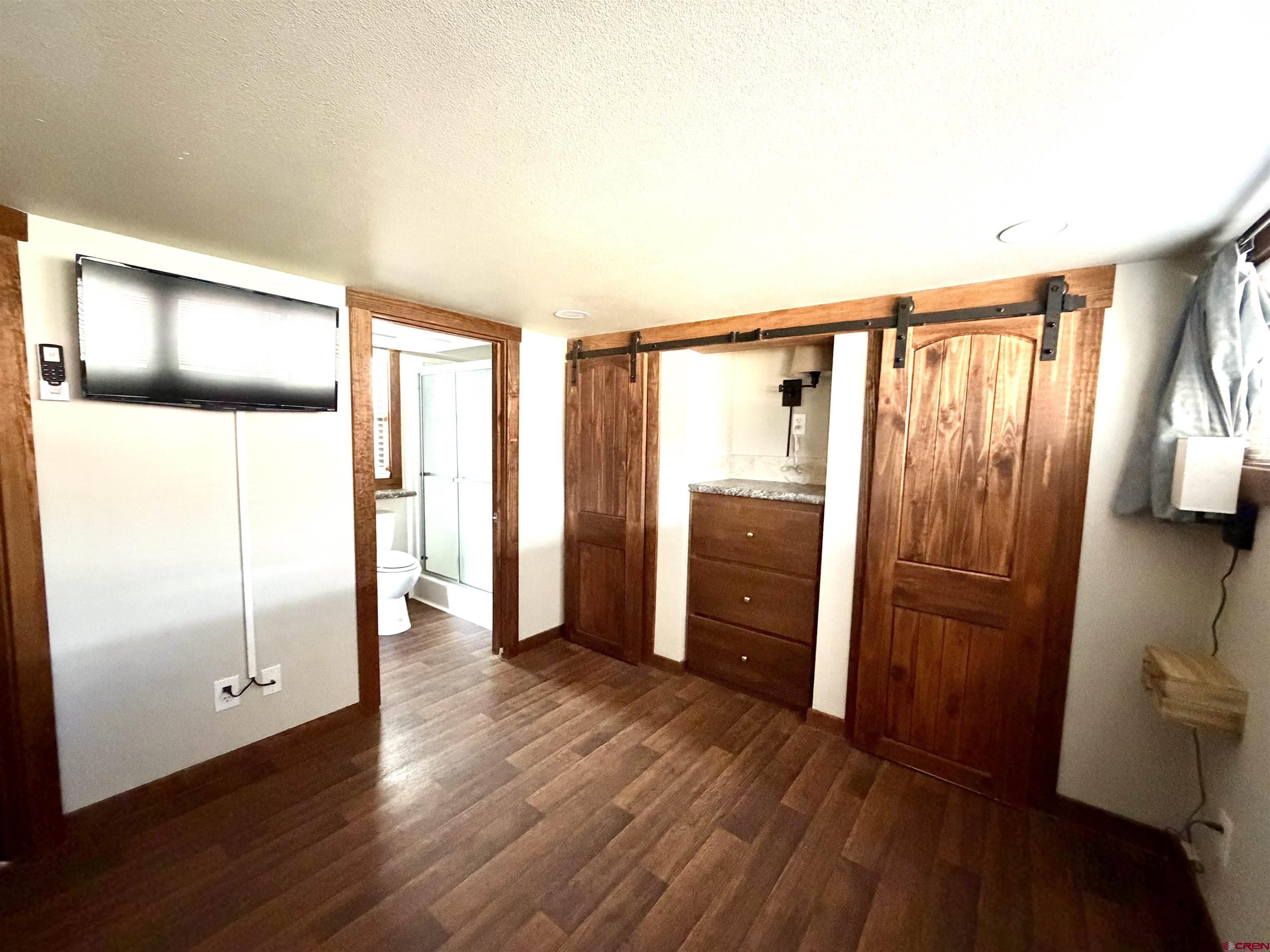 4115 County Road 17 Ridgway, CO 81432 - Photo 14 of 21 a view of walk in closet with furniture and wooden floor