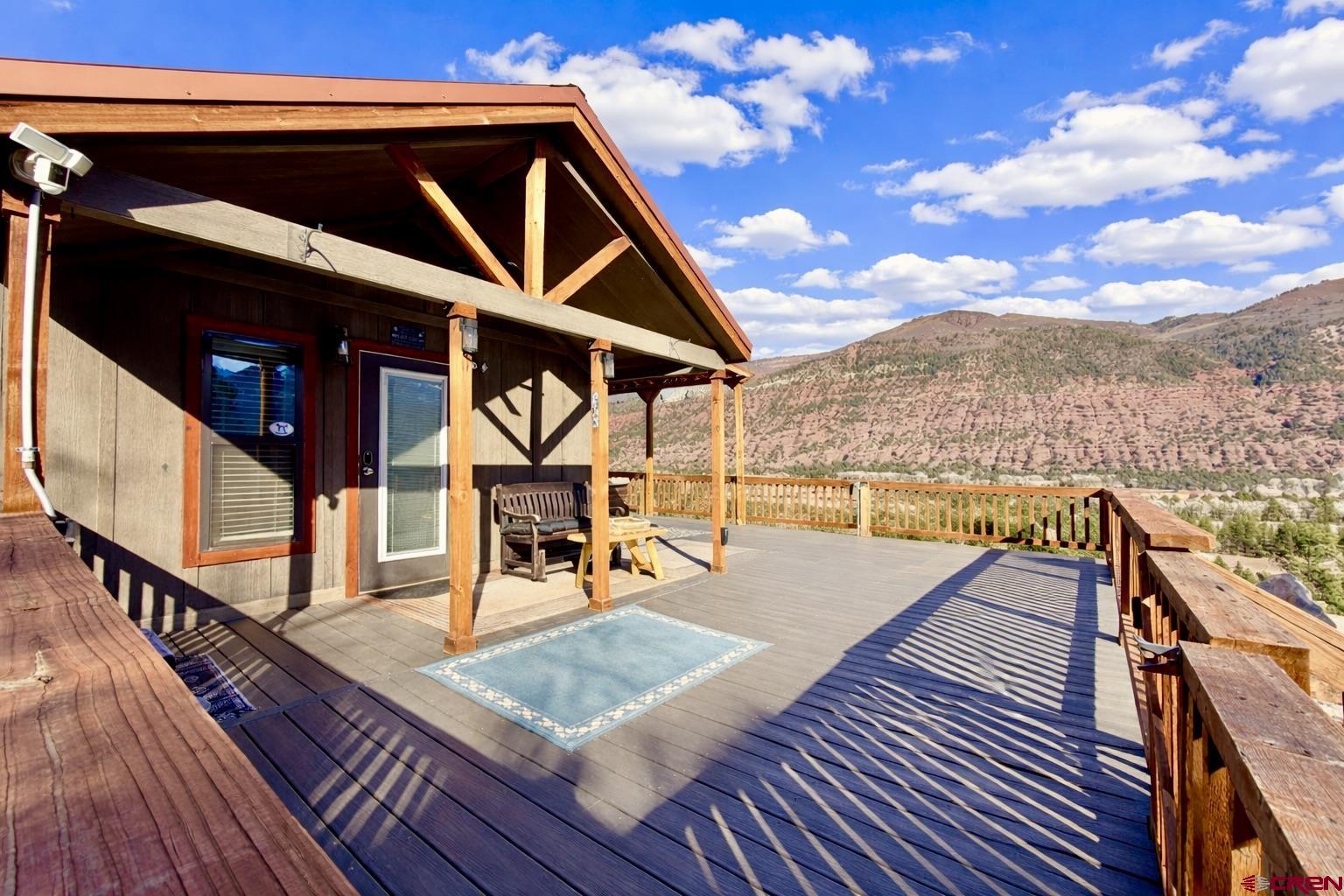 4115 County Road 17 Ridgway, CO 81432 - Photo 6 of 21 a view of a balcony with wooden floor and outdoor seating