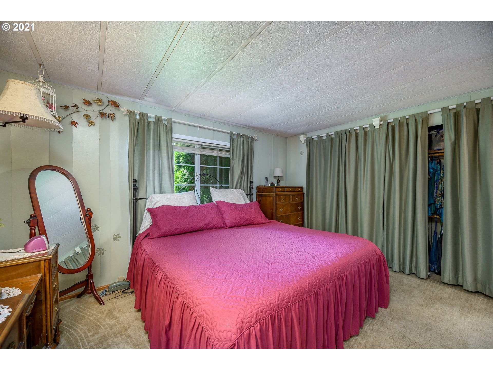 7400 Ash Street Grand Ronde, OR 97347 - Photo 12 of 23 a bed room with a bed and a large mirror