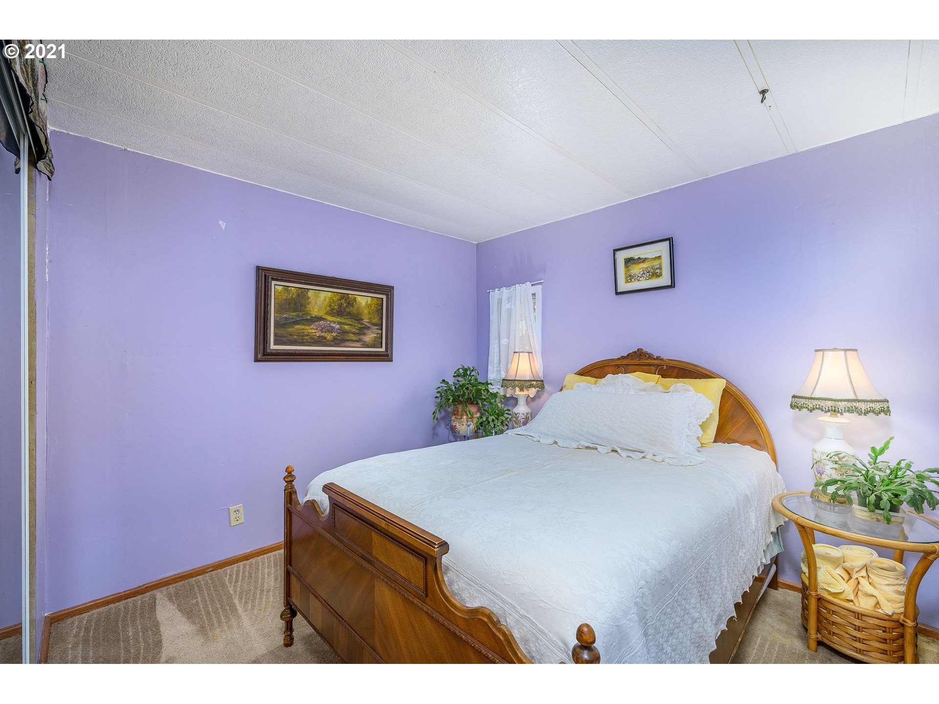 7400 Ash Street Grand Ronde, OR 97347 - Photo 14 of 23 a bed room with a bed and a painting on the wall