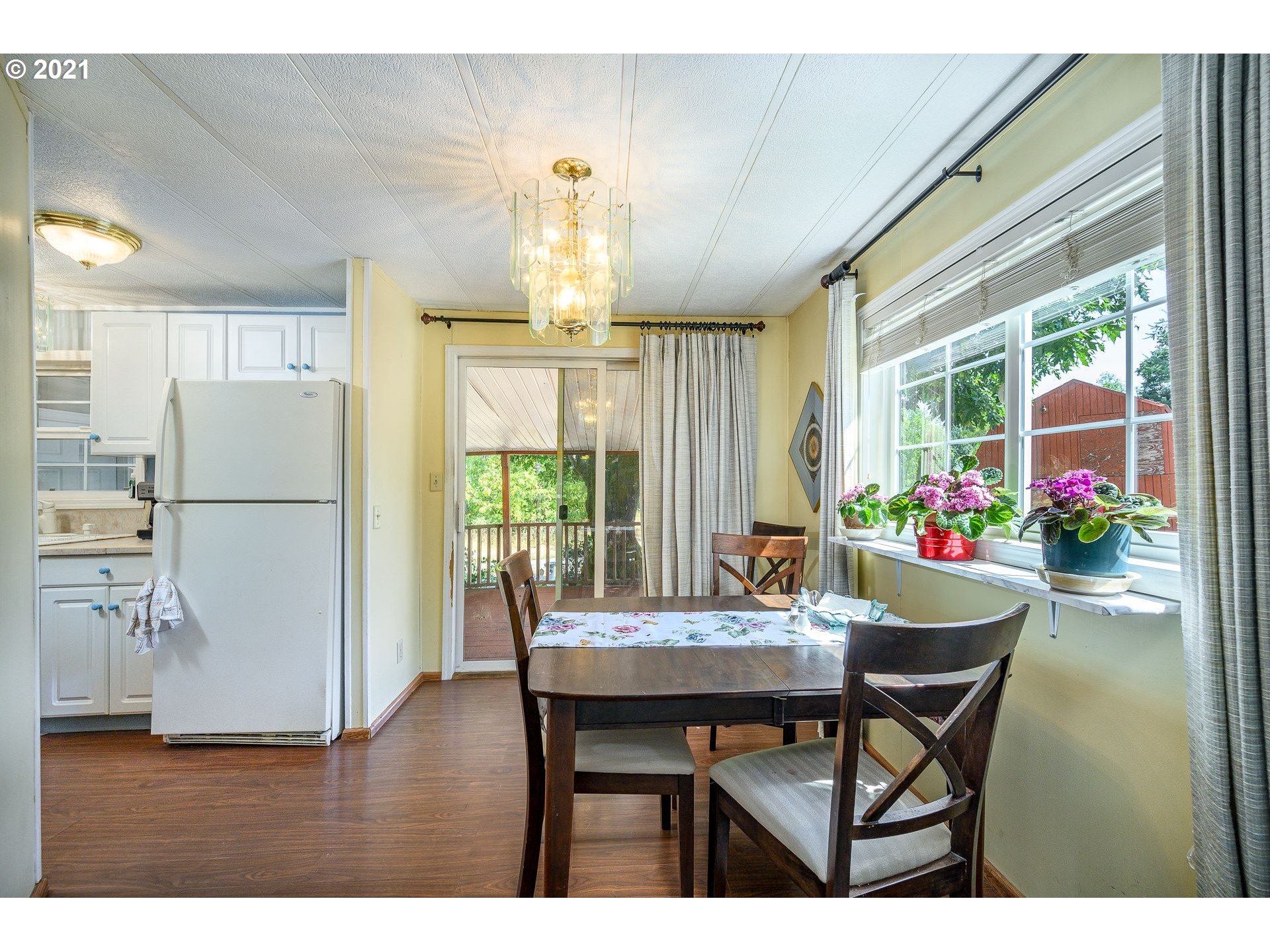 7400 Ash Street Grand Ronde, OR 97347 - Photo 10 of 23 a dining room with furniture a chandelier and wooden floor