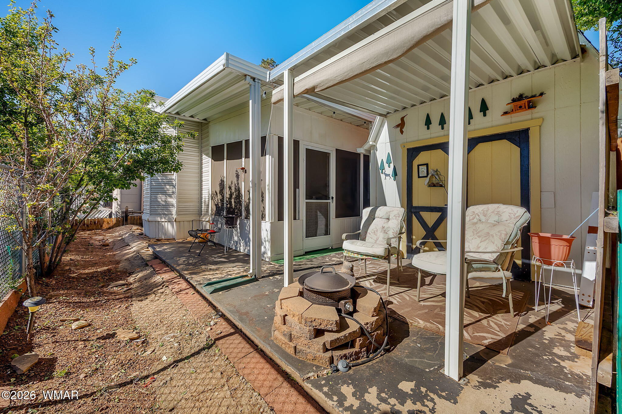 2725 Whiskey Road Overgaard, AZ 85933 - Photo 22 of 32 a view of a patio with table and chairs with wooden floor and fence