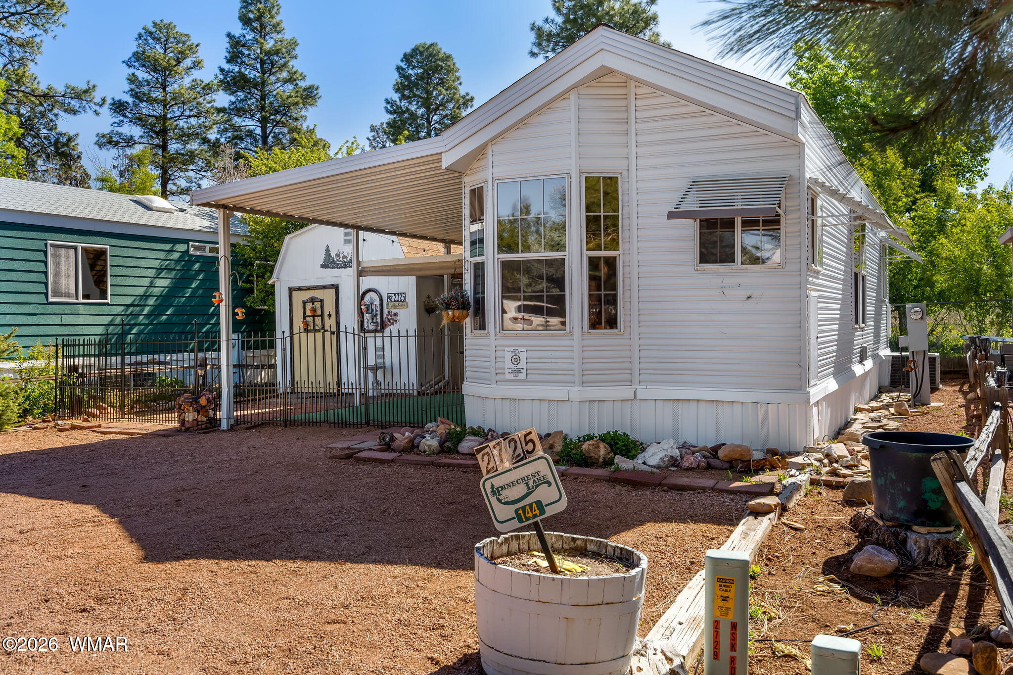 2725 Whiskey Road Overgaard, AZ 85933 - Photo 3 of 32 a front view of a house with patio
