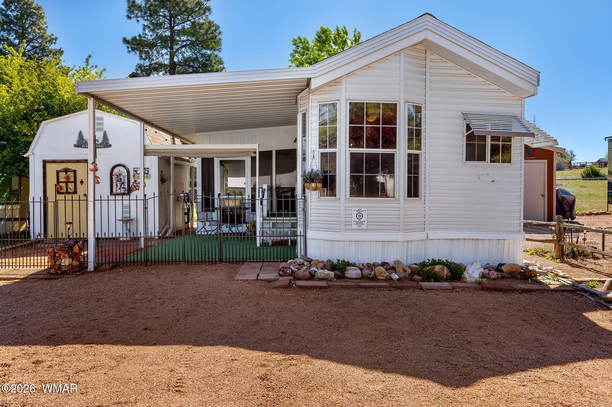 2725 Whiskey Road Overgaard, AZ 85933 - Photo 4 of 32 a front view of a house with a yard