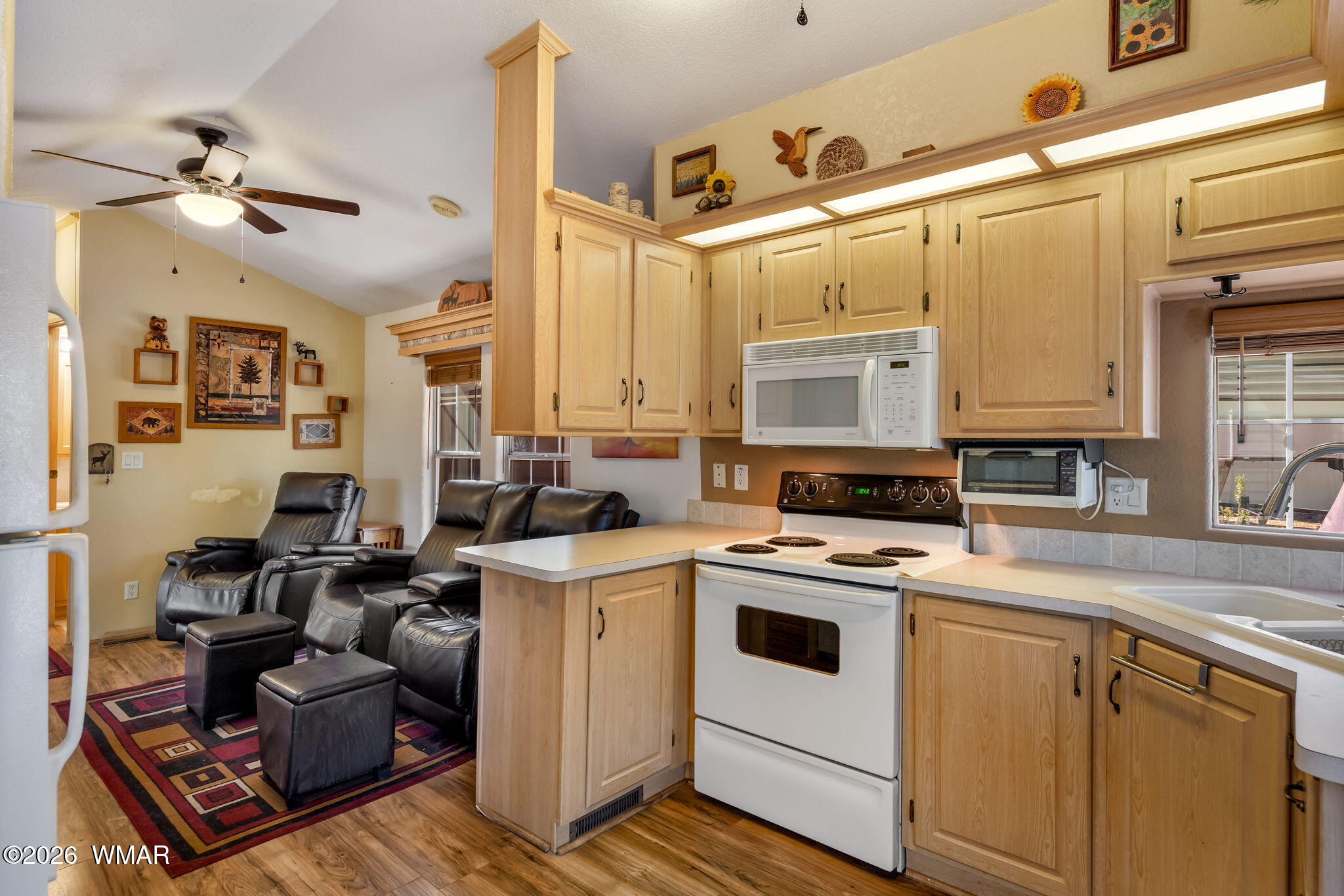 2725 Whiskey Road Overgaard, AZ 85933 - Photo 9 of 32 a view of a kitchen with cabinets stainless steel appliances and a window