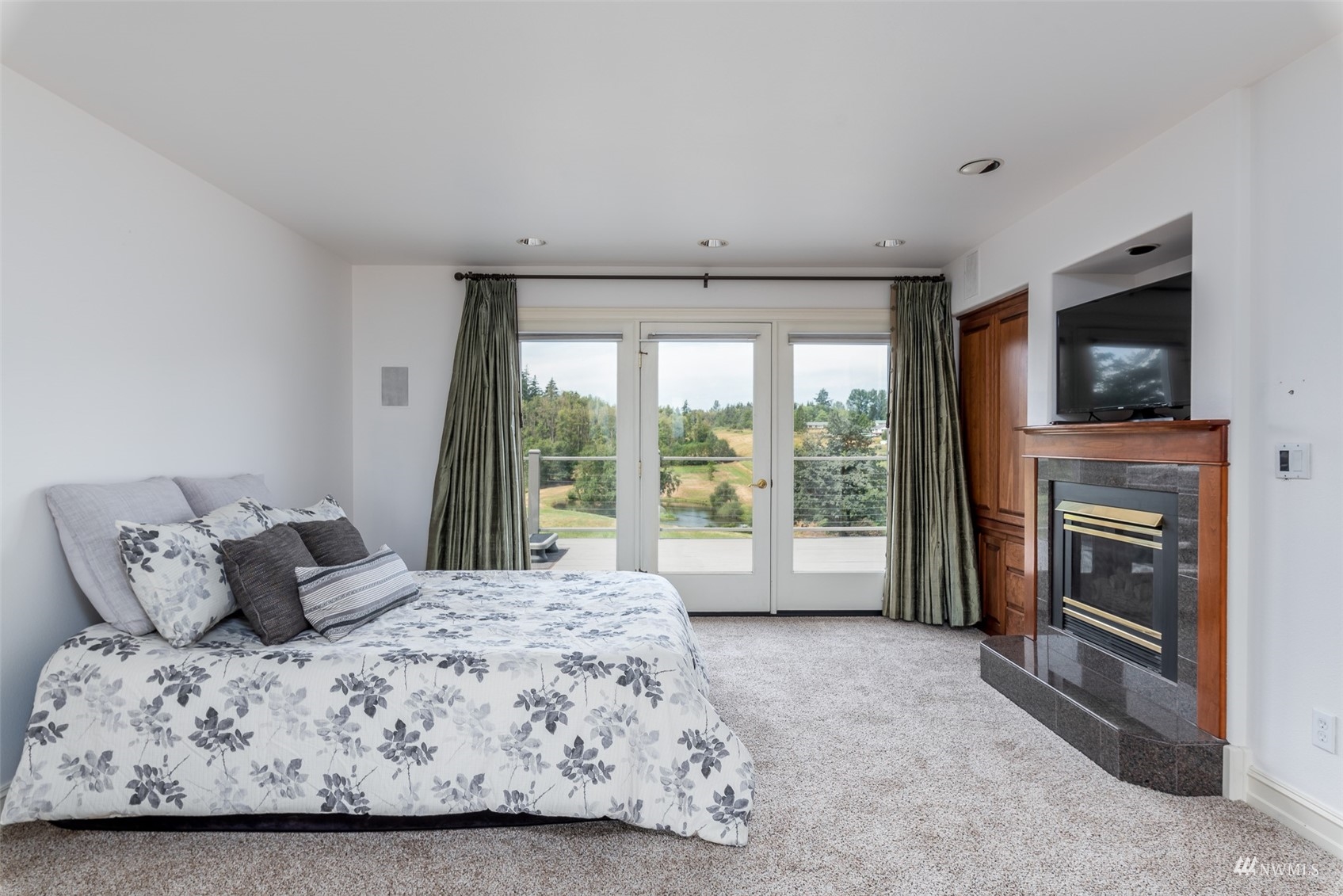9647 Axlund Road Lynden, WA 98264 - Photo 15 of 39 a large bedroom with a bed and a television