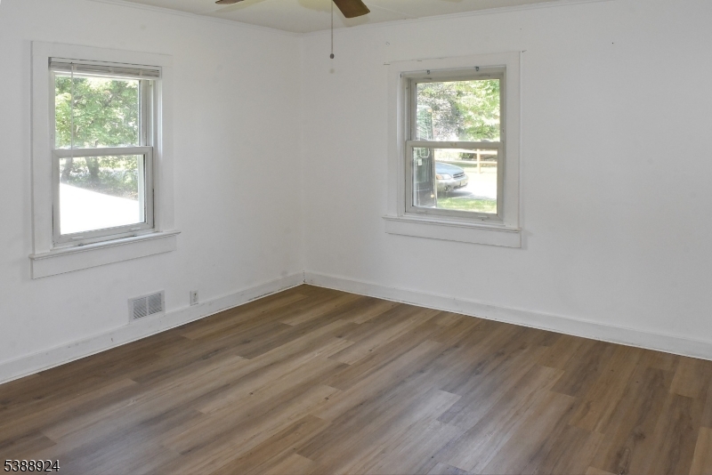 7 West Maple Avenue Succasunna, NJ 07876 - Photo 2 of 14 a view of an empty room with wooden floor and a window