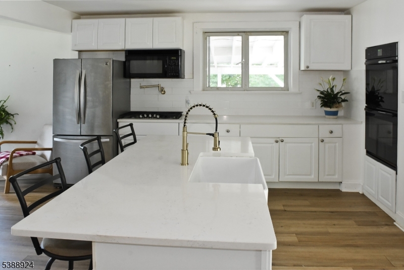 7 West Maple Avenue Succasunna, NJ 07876 - Photo 8 of 14 a kitchen with stainless steel appliances a microwave a sink a refrigerator and cabinets