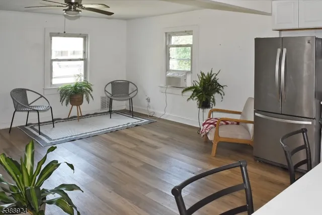 a living room with furniture a window and potted plants